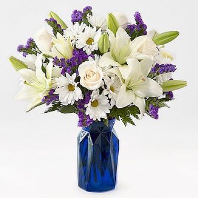 Gift your friends and family the freshest and most beautiful bouquet of lilies, roses and statice. Perfect for complementing any message you want to send, our Beyond Blue Bouquet features a deep blue vase and a gorgeous array of white and purple blooms.
STANDARD
C Quantity	Color	Description
3	Ivory	50 cm Standard Rose - Escimo
2	White	LA Hybrid Lily
5	White	Daisy Pom
3	Purple	Filler - Sinuata Statice
3	Green	Green - Leather Leaf
DELUXE
C Quantity	Color	Description
5	Ivory	50 cm Standard Rose - Escimo
3	White	LA Hybrid Lily
5	White	Daisy Pom
4	Purple	Filler - Sinuata Statice
3	Green	Green - Leather Leaf
PREMIUM
C Quantity	Color	Description
6	Ivory	50 cm Standard Rose - Escimo
4	White	LA Hybrid Lily
5	White	Daisy Pom
4	Purple	Filler - Sinuata Statice
3	Green	Green - Leather Leaf
