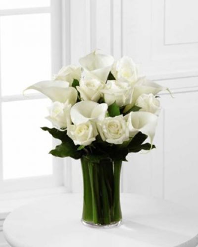 <p>The FTD® Sweet Solace™ Bouquet is a divinely elegant arrangement that encourages peace and offers your sympathy. Brilliant white roses and calla lilies are simply set amongst lush greens in a clear glass gathering vase to create a meaningful gift that will help your special recipient through this trying time of grief and loss.</p>